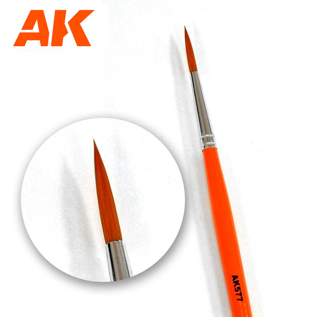 Orange fine-tipped paint brush, with a magnified view of its sharp point