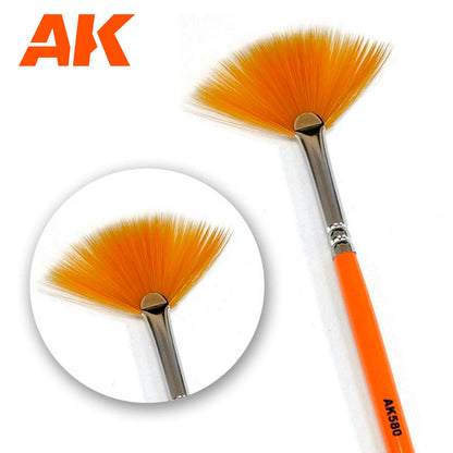 An orange fan brush with silver ferrule, orange handle marked AK580. Includes a close-up inset of the bristles. AK logo