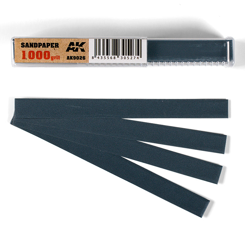 AK Interactive 1000 grit sandpaper pack: clear case with label, plus five fanned-out dark gray strips