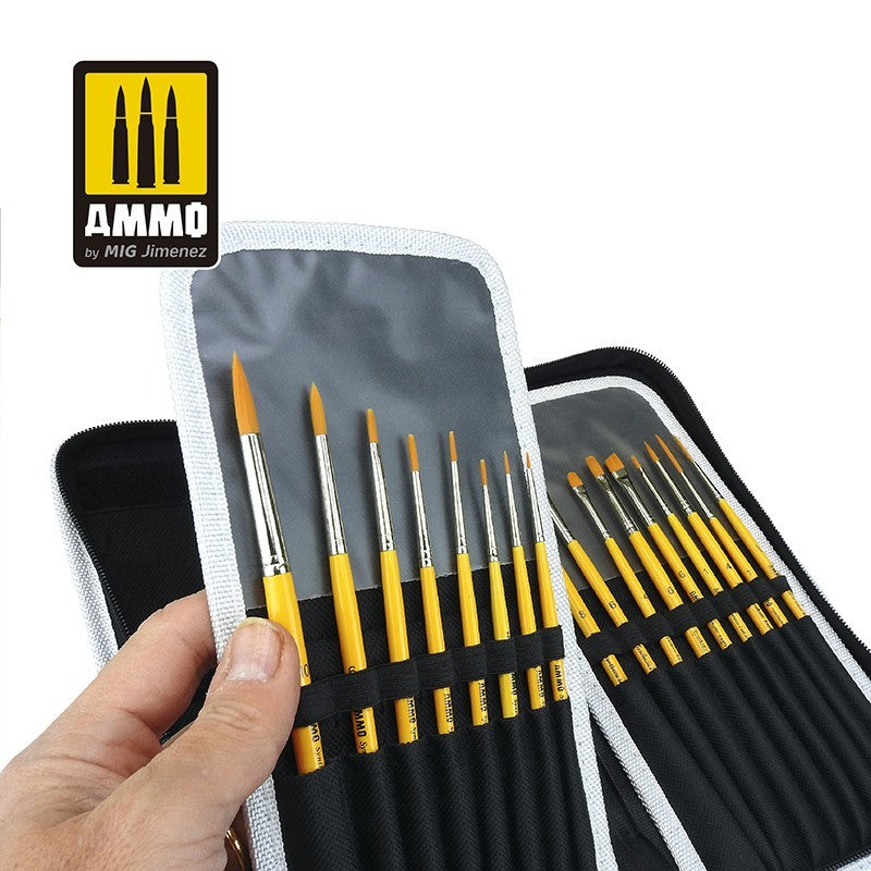 A hand holds open a protective storage set, revealing rows of various paintbrushes with yellow handles organized inside