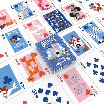 Bicycle Disney Cats & Dogs playing card deck box surrounded by various character cards spread on a white surface