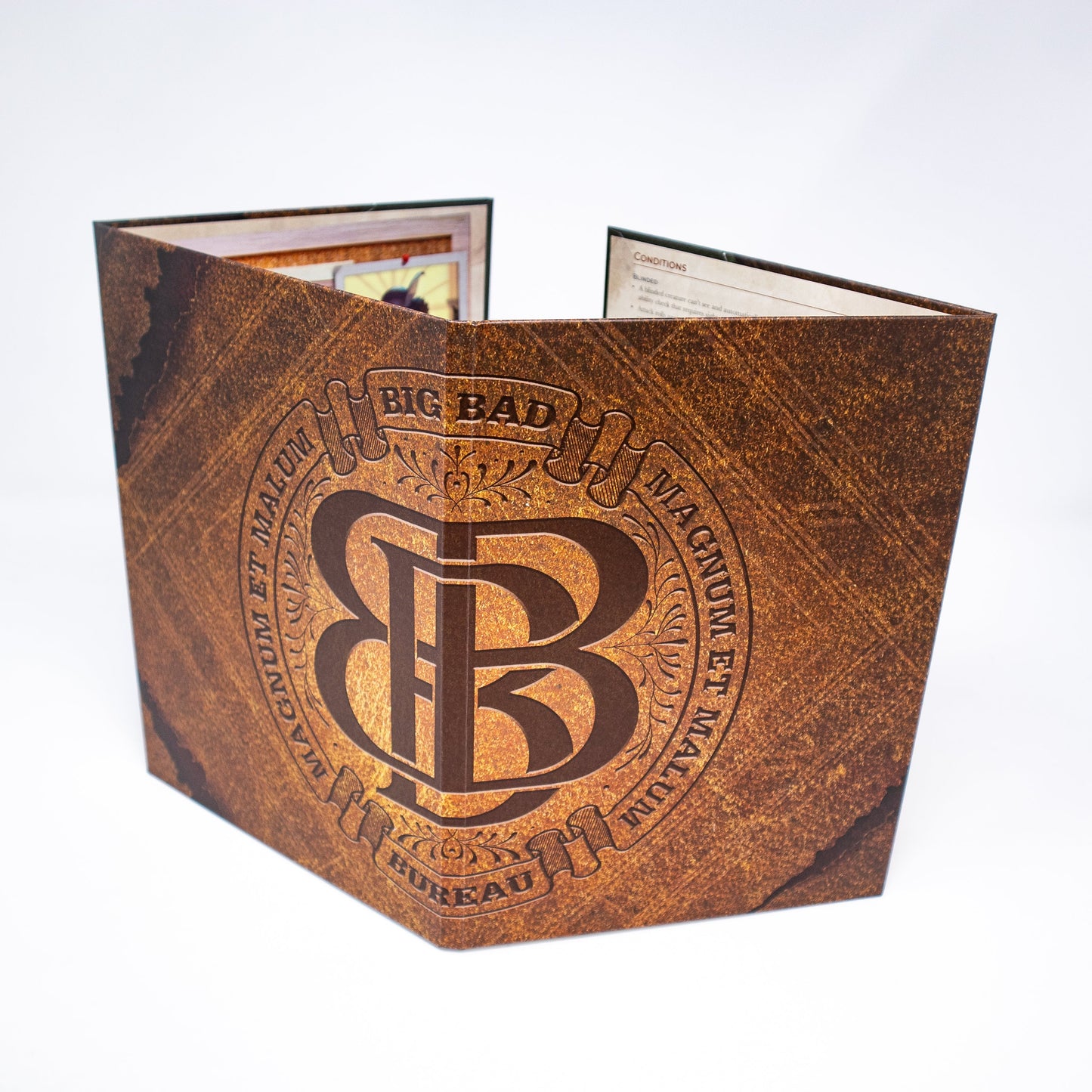 An open Hit Point Press Big Bads Big Bad Bureau GM Screen with a brown textured design, a large BB monogram, and Big Bad Magnum Et Malum Bureau text