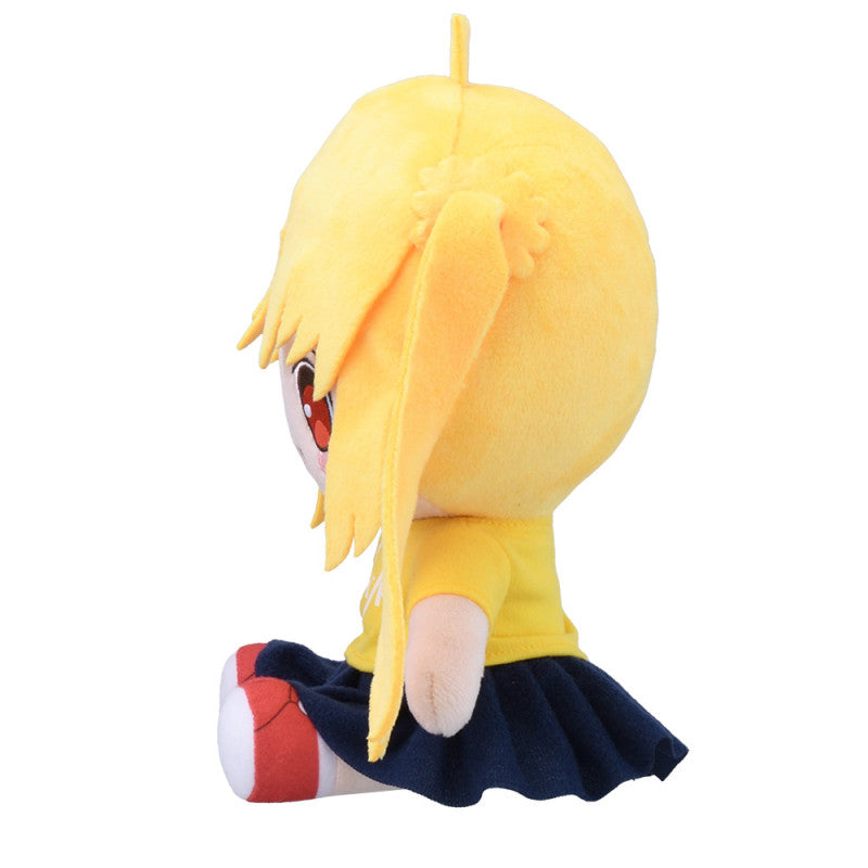 Side view of yellow plush doll with short bangs and a long ponytail