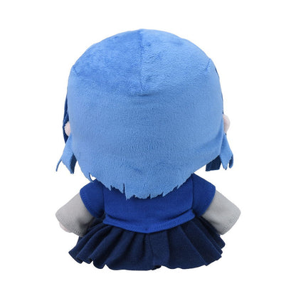 Back view of a blue stuffed plush doll wearing a dark blue dress