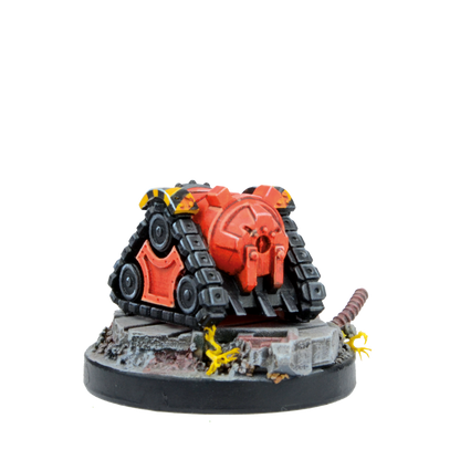 A red and black miniature sci-fi tank model with yellow hazard stripes, on a detailed rubble base