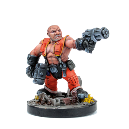 Painted sci-fi miniature of a bald, muscular man in orange, pointing a large futuristic gun forward