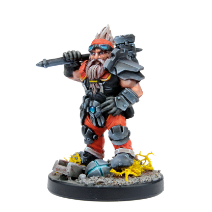 Painted fantasy miniature of a bearded, armored dwarf with goggles, holding a hammer over his shoulder