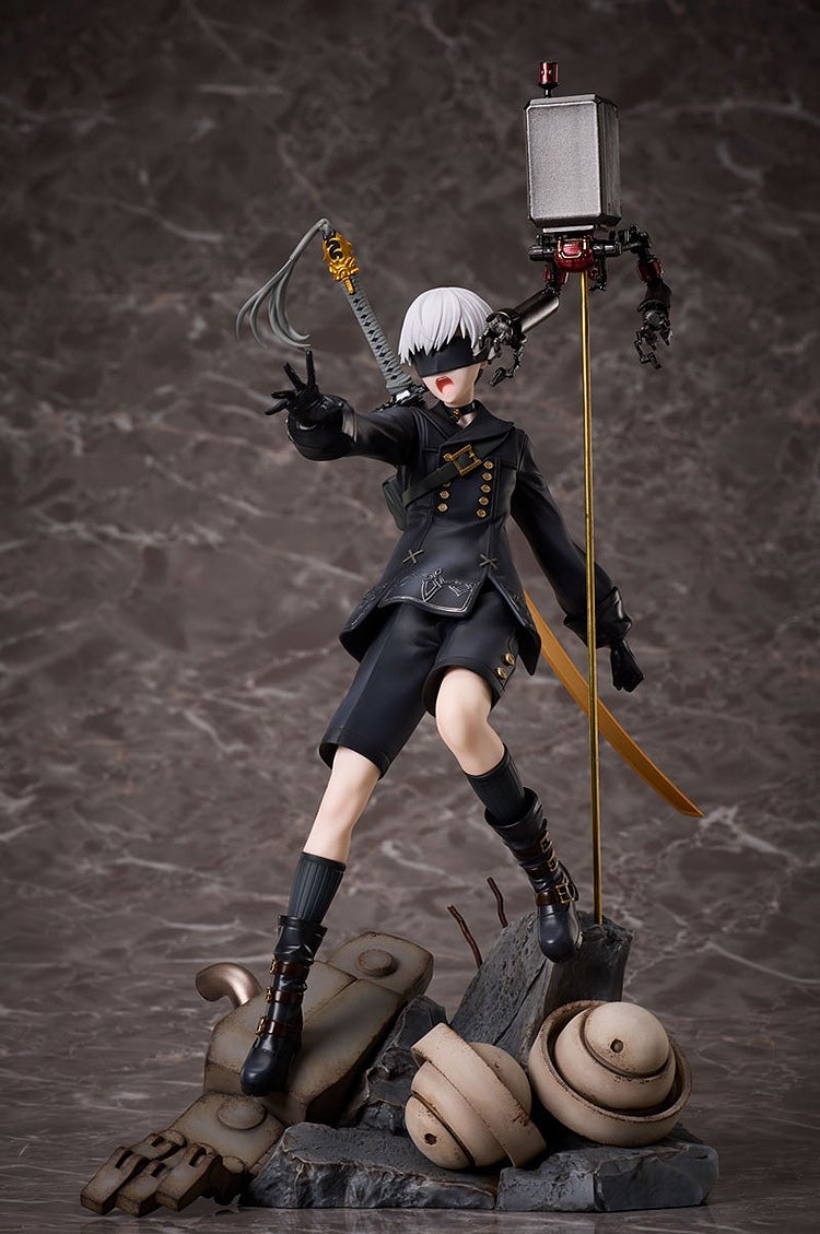 Nier: Automata 2B figure, blindfolded, with white hair, black outfit, sword, and a floating Pod, posed dynamically on a rubble base