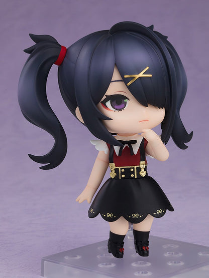 A chibi girl figure with black twin ponytails and a gold X clip, wearing a red and black dress, thoughtfully posed with a finger on her chin