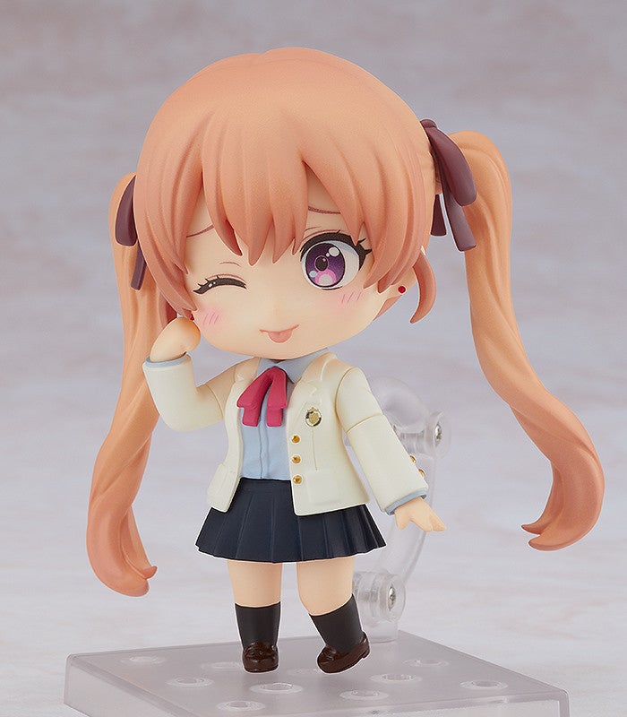 Alternate pose with hand extended holding a phone and a playful expression