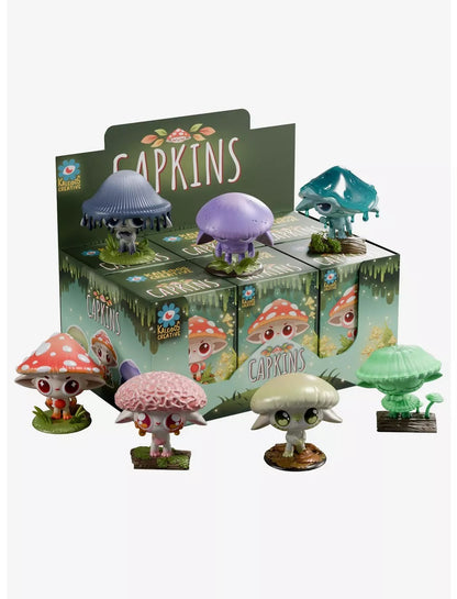 Colorful Capkins mushroom collectible figures displayed on and around their retail blind box packaging