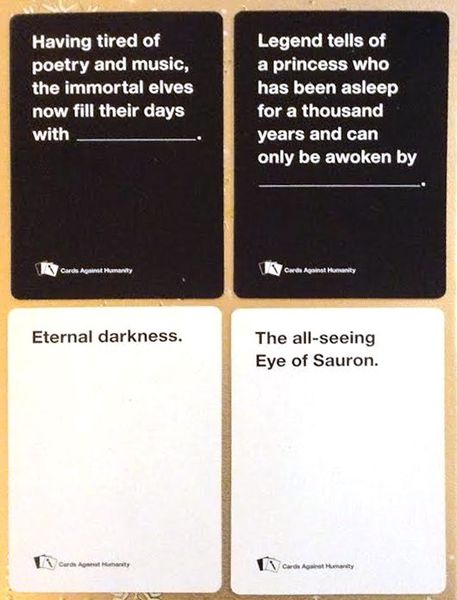 Four Cards Against Humanity cards two black question cards and two white answer cards