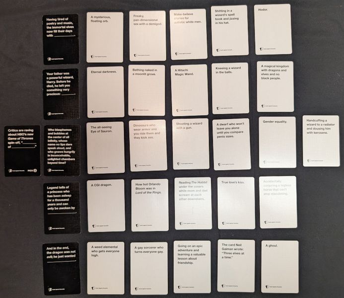 Cards from a Cards Against Humanity fantasy themed deck laid out