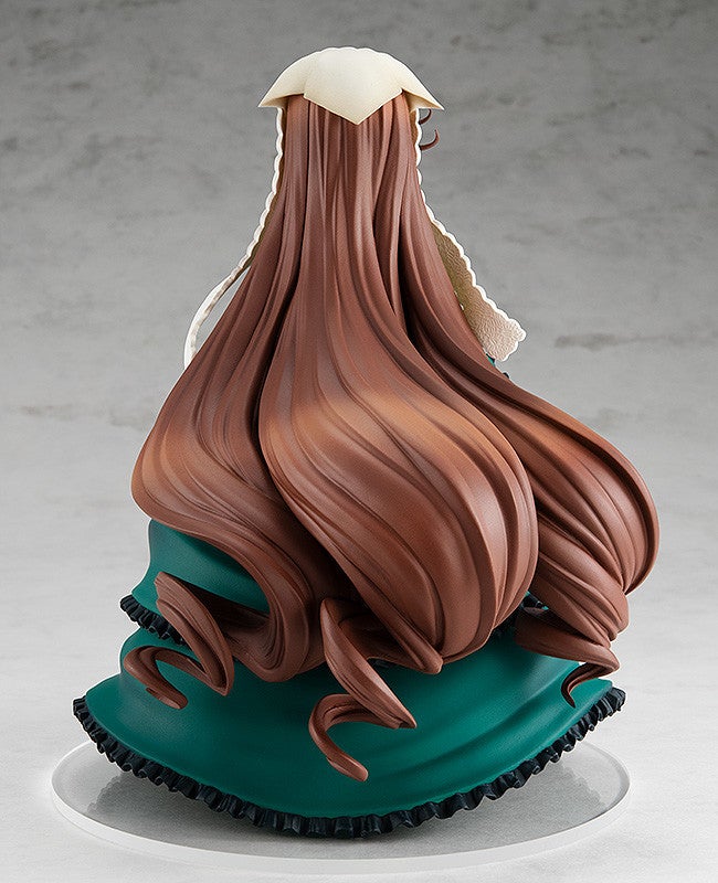 Back view of a figurine featuring a woman with long flowing brown hair styled with curls wearing a dark teal dress