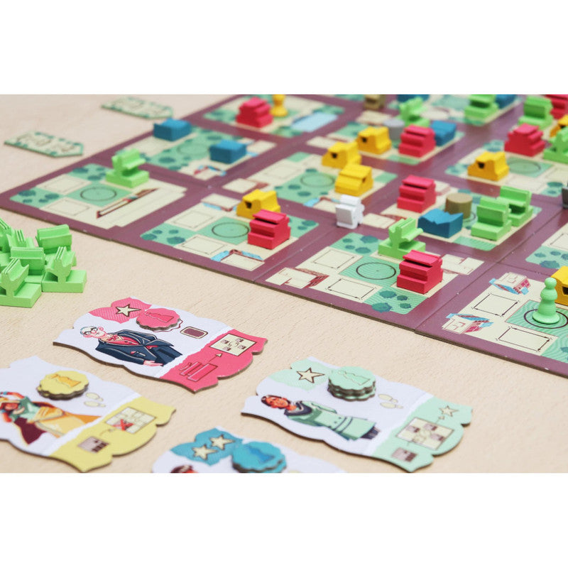 Chandigarh board game setup with colorful building pieces and character cards depicting city life scenes and notable figures