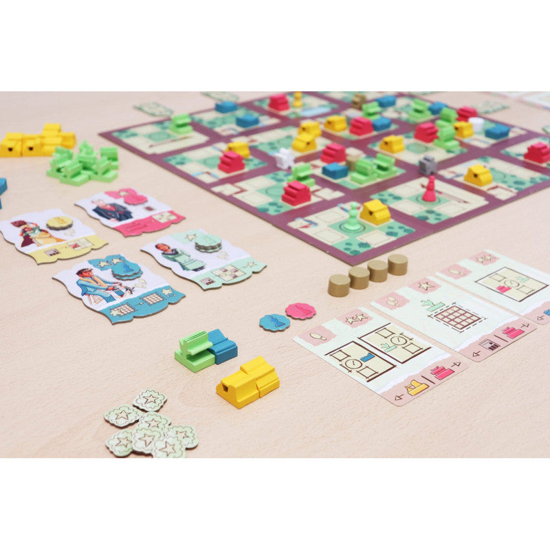 A board game set on a light wooden table featuring the Chandigarh board game with colorful buildings cars and trees