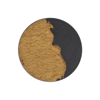 A circular black model base, mostly covered with lumpy, textured brown mud.