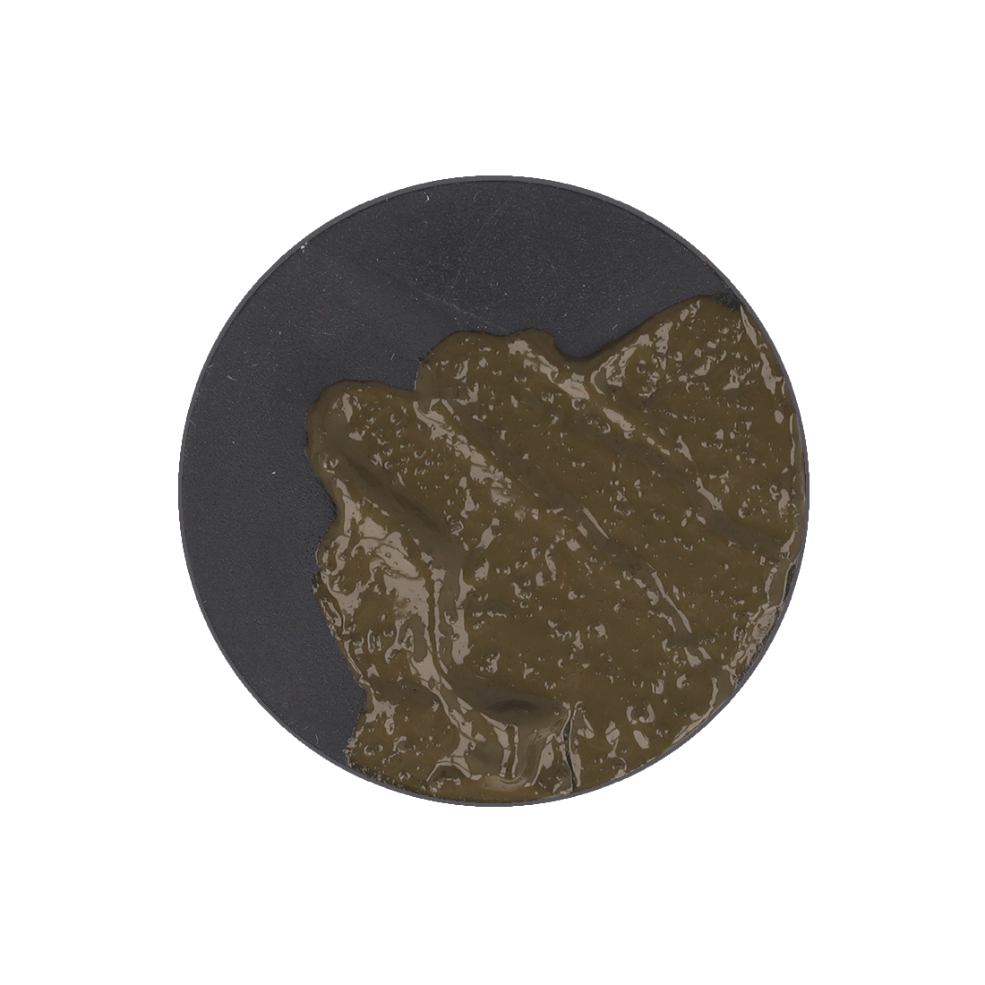 A thick, dark olive green paste is spread on a black circular base.
