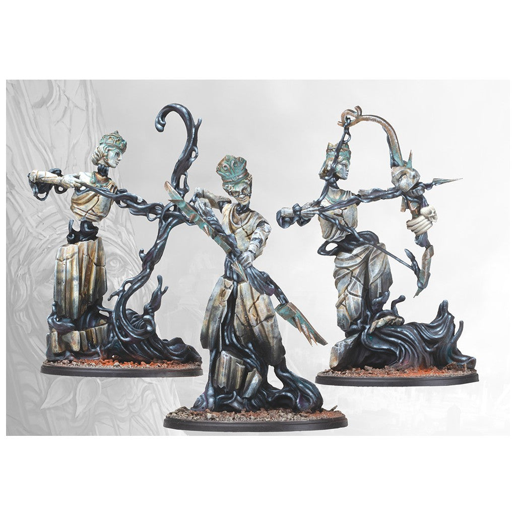 Set of three fantasy miniatures of reanimating stone statues with dark tendrils, two holding weapons