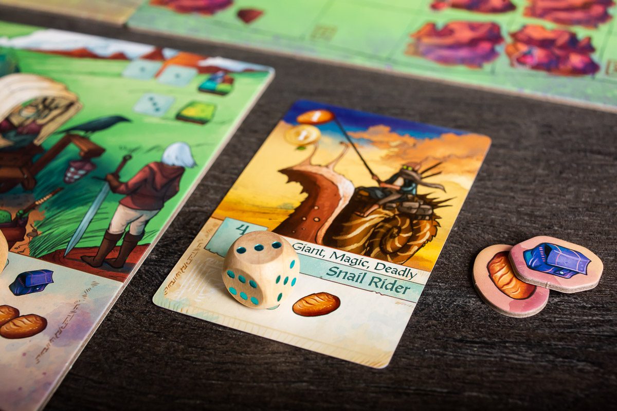 A fantasy board game showing a "Snail Rider" card, a wooden die with 4 pips, and resource tokens