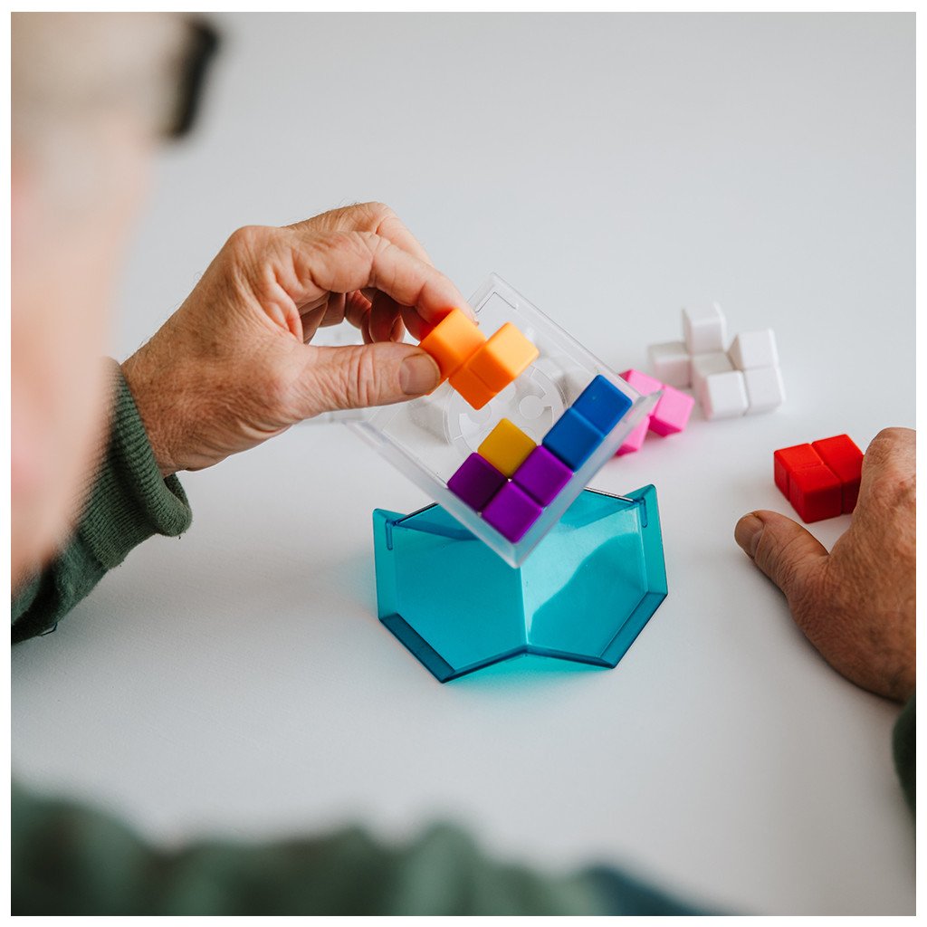 Man assembling Smart Games CubIQ Puzzle