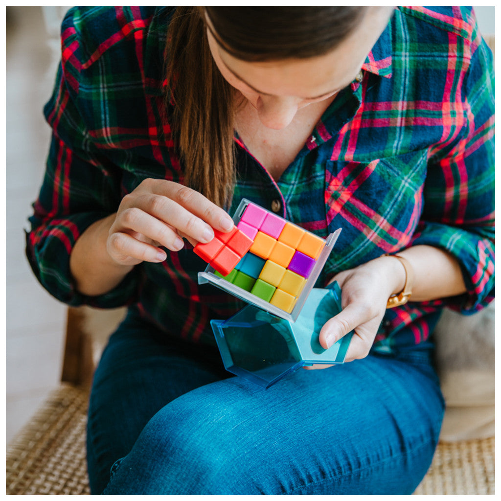 Woman assembling Smart Games CubIQ Puzzle