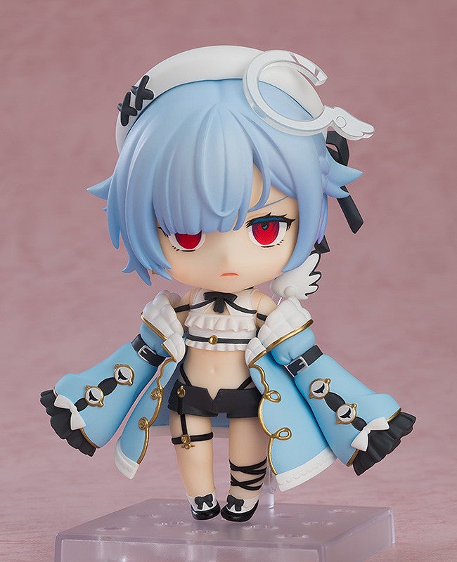 Nendoroid Ganyu with blue hair red eyes white winged headdress light blue jacket and black shorts standing on a display stand