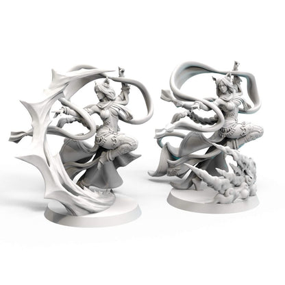 Two unpainted grey fantasy miniatures of women with animal ears, leaping amidst flowing ribbons and stylized elemental bases