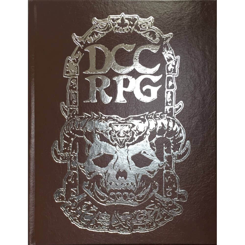 Dark brown DCC RPG book cover with silver foil embossed logo: 'DCC RPG' text above a horned skull with a pentagram, surrounded by ornate fantasy designs