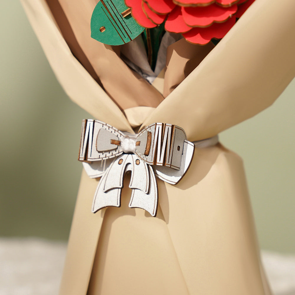 Detailed view of a beige-wrapped bouquet featuring a decorative white wooden puzzle bow