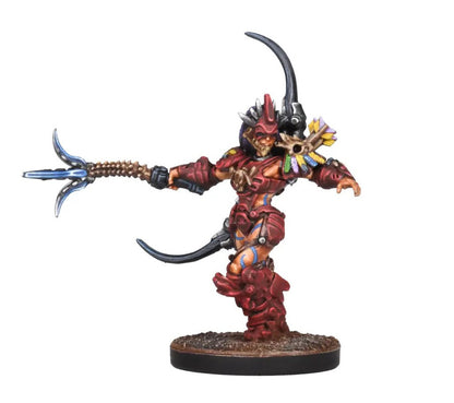 Red-armored female fantasy warrior miniature with a horned helmet, skull, and feathers, extending a glowing blue-tipped spear