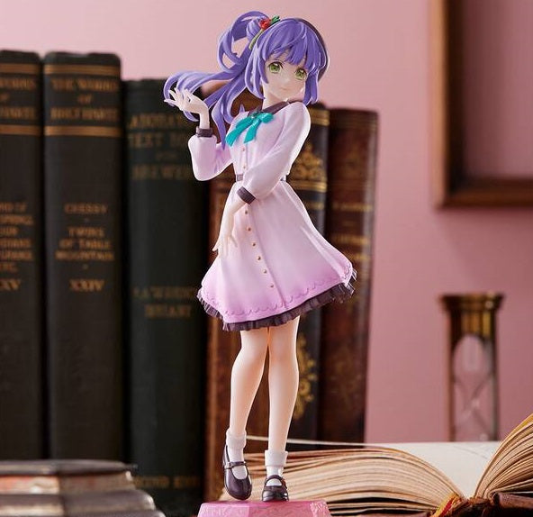 Close-up of Kozue Otomune figure with a soft smile, set against a decorated background