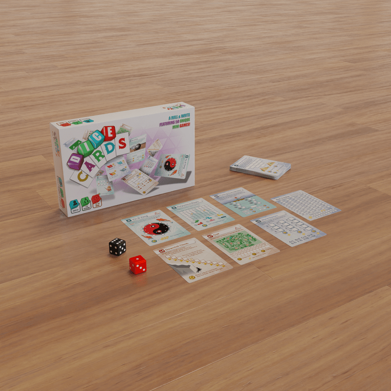 A "Dice Cards" roll & write game box, individual cards, and two dice spread on a wooden floor