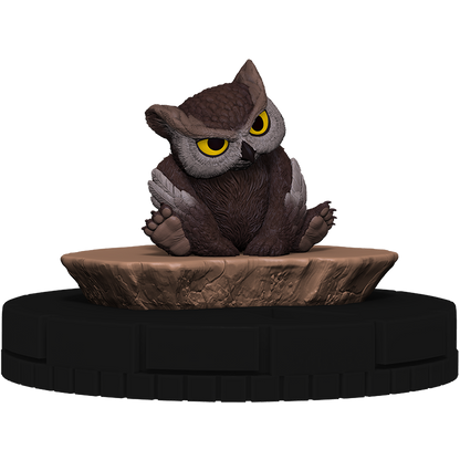 Stylized brown owl miniature with large yellow eyes, seated on a textured brown rock base