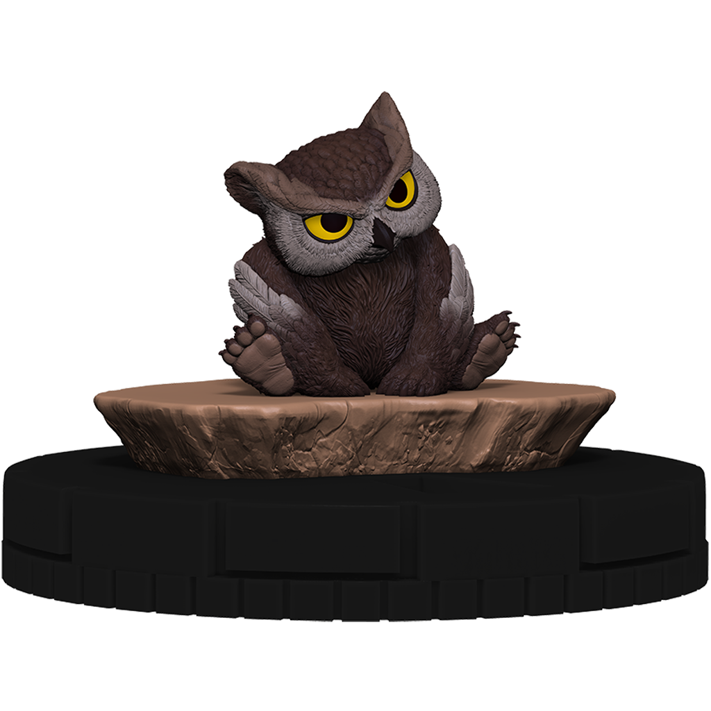 Stylized brown owl miniature with large yellow eyes, seated on a textured brown rock base
