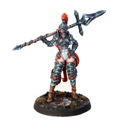 Painted miniature of an armored female knight with red hair & plumed helmet, holding a polearm over her shoulder