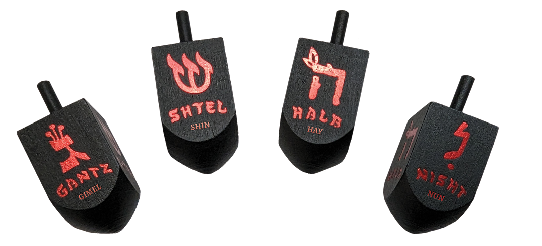 Four black dreidels with red Hebrew letters and Yiddish game terms, dynamically arranged on a white background.