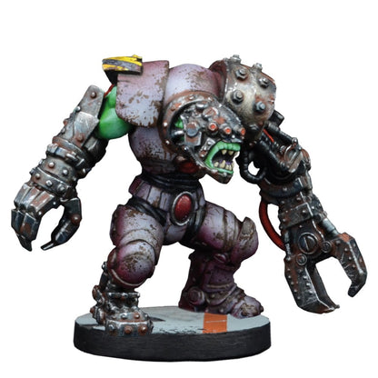 A painted miniature of a heavily armored, green-skinned cybernetic Ork with a large power claw, in an aggressive stance
