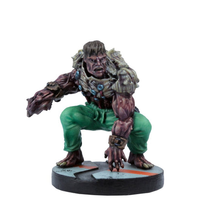 A muscular, mutated humanoid game miniature in green pants and bone armor, crouching low with an angry expression