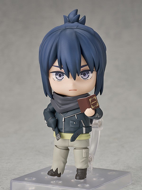 Nendoroid figure of anime boy with dark blue hair gray scarf black jacket and tan pants holding a brown book