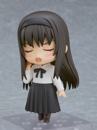 Chibi anime figure of a girl with long dark brown hair wearing a white shirt and black pleated skirt looking tired and yawning