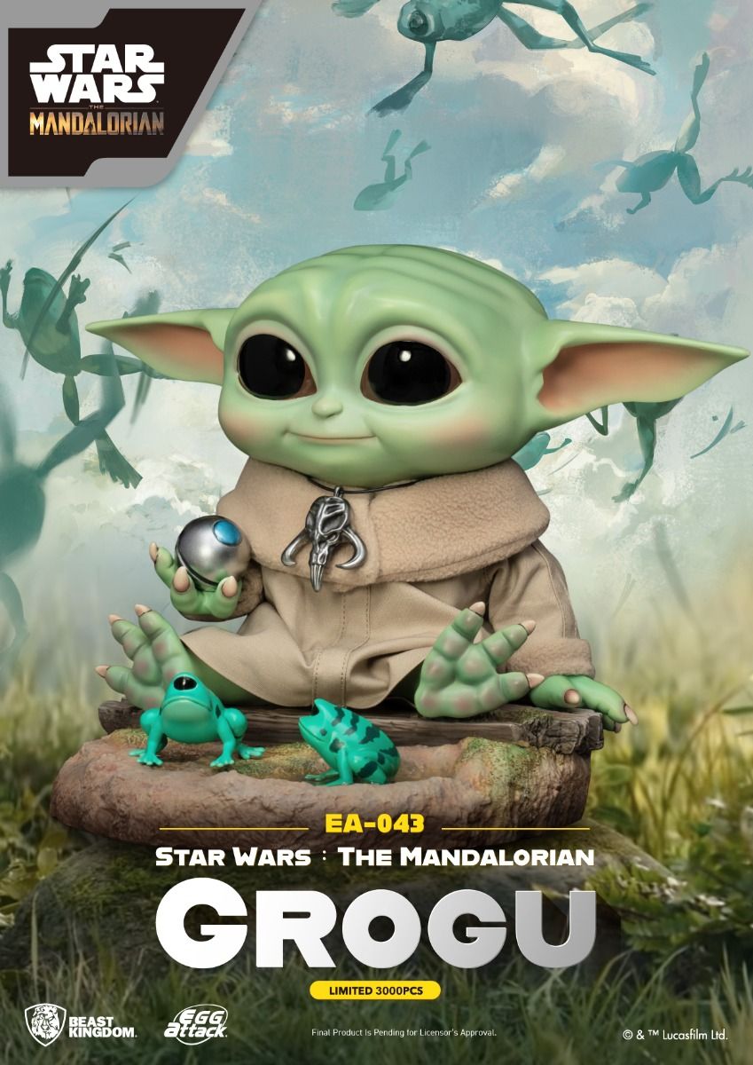Grogu figure from Star Wars The Mandalorian with two frogs and a metal ball accessory seated on a rock base