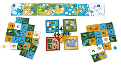 A vibrant board game setup with numerous animal habitat tiles, numbered map pieces, and central scoring/action boards