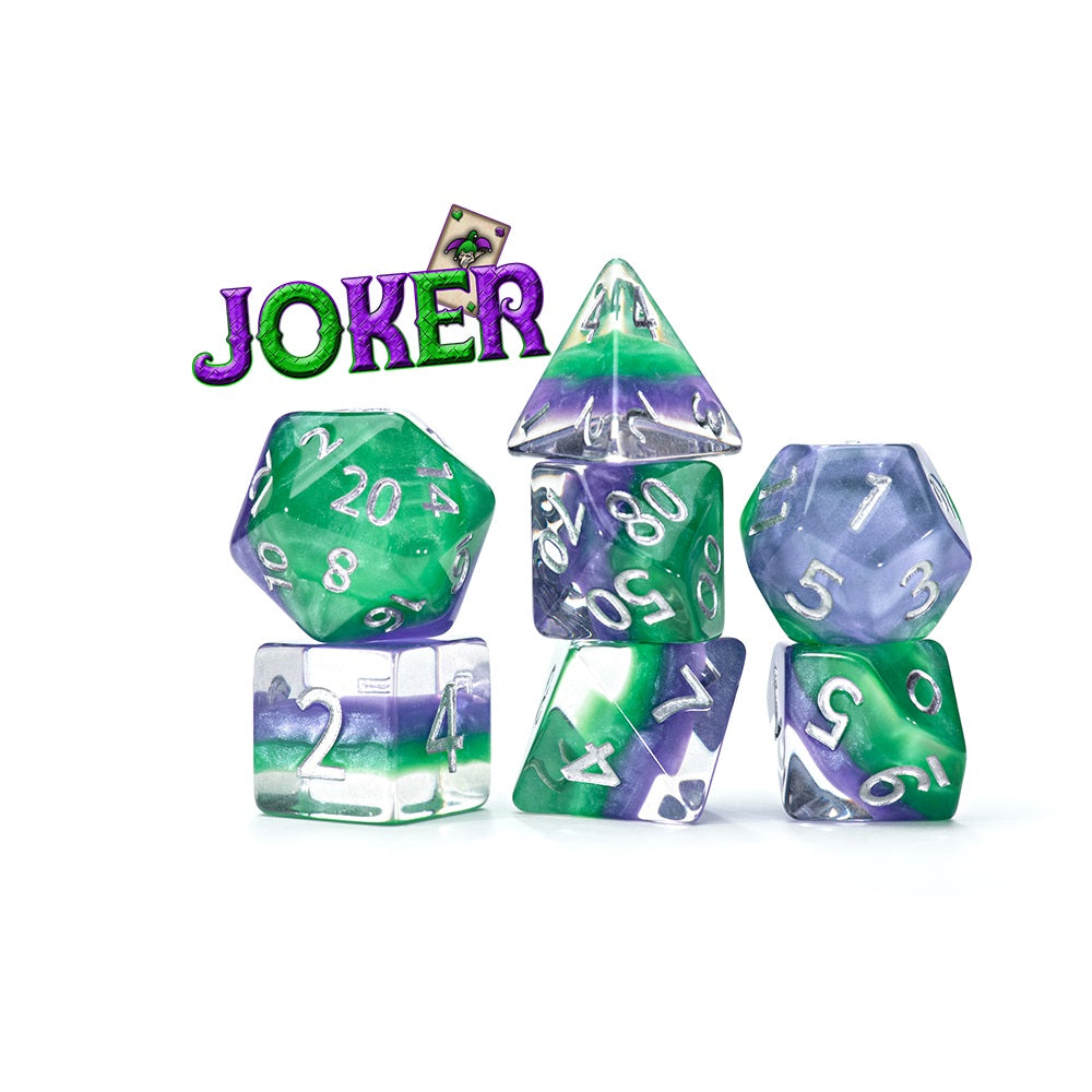 A seven-piece Joker Eclipse RPG Dice Set in green, purple, and clear swirls with silver numbers, displayed on a white background alongside a JOKER text graphic