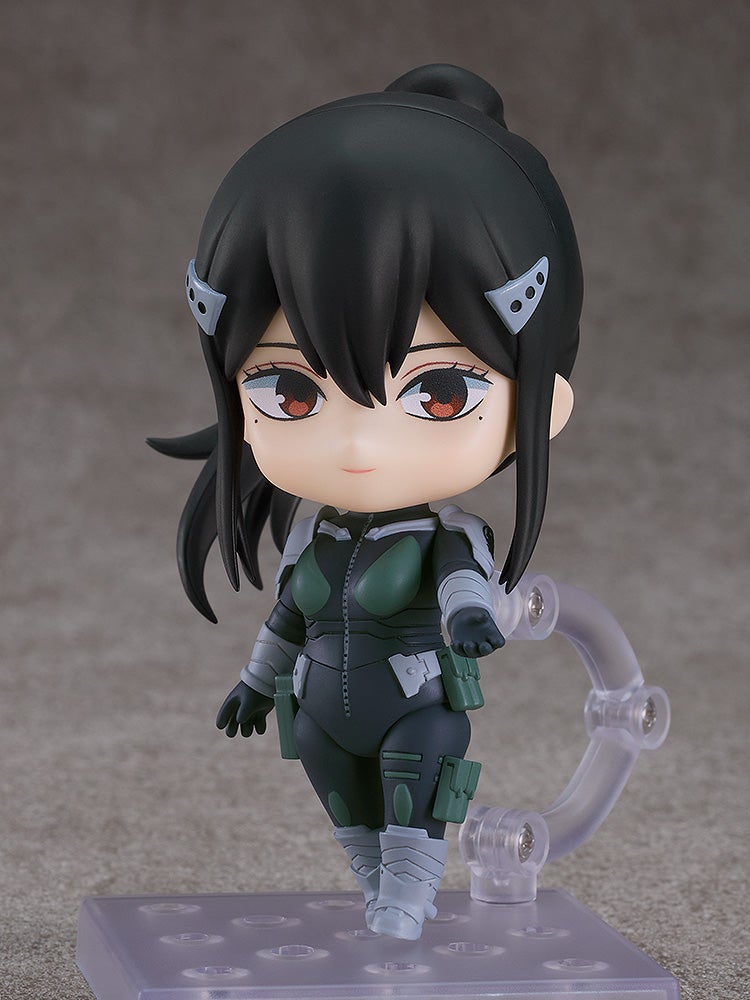 Close-up of determined face, aiming her weapon with visible cheek marks and raised eyebrows