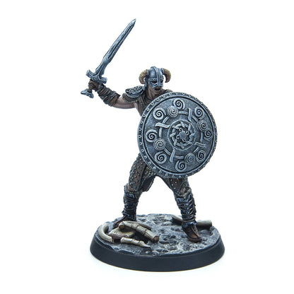 A miniature figure of the Dragonborn from Skyrim, armored with a horned helmet, raising a sword and holding a round shield