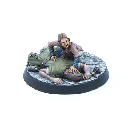 Painted miniature: Fanged figure pins a prone, bleeding victim on a cobblestone base