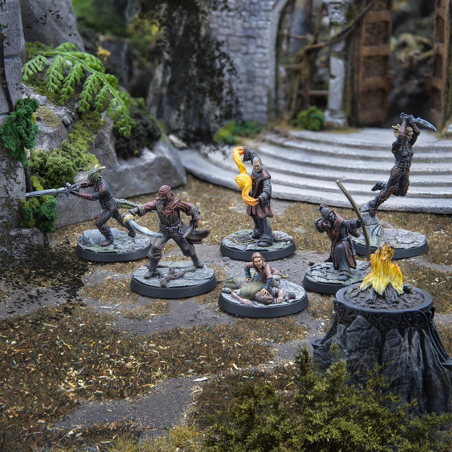 A collection of painted fantasy miniatures depicting a battle in ancient ruins