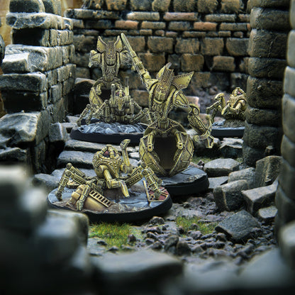 Golden robot and spider-like miniatures stand in stone ruins, one larger robot wielding a sword