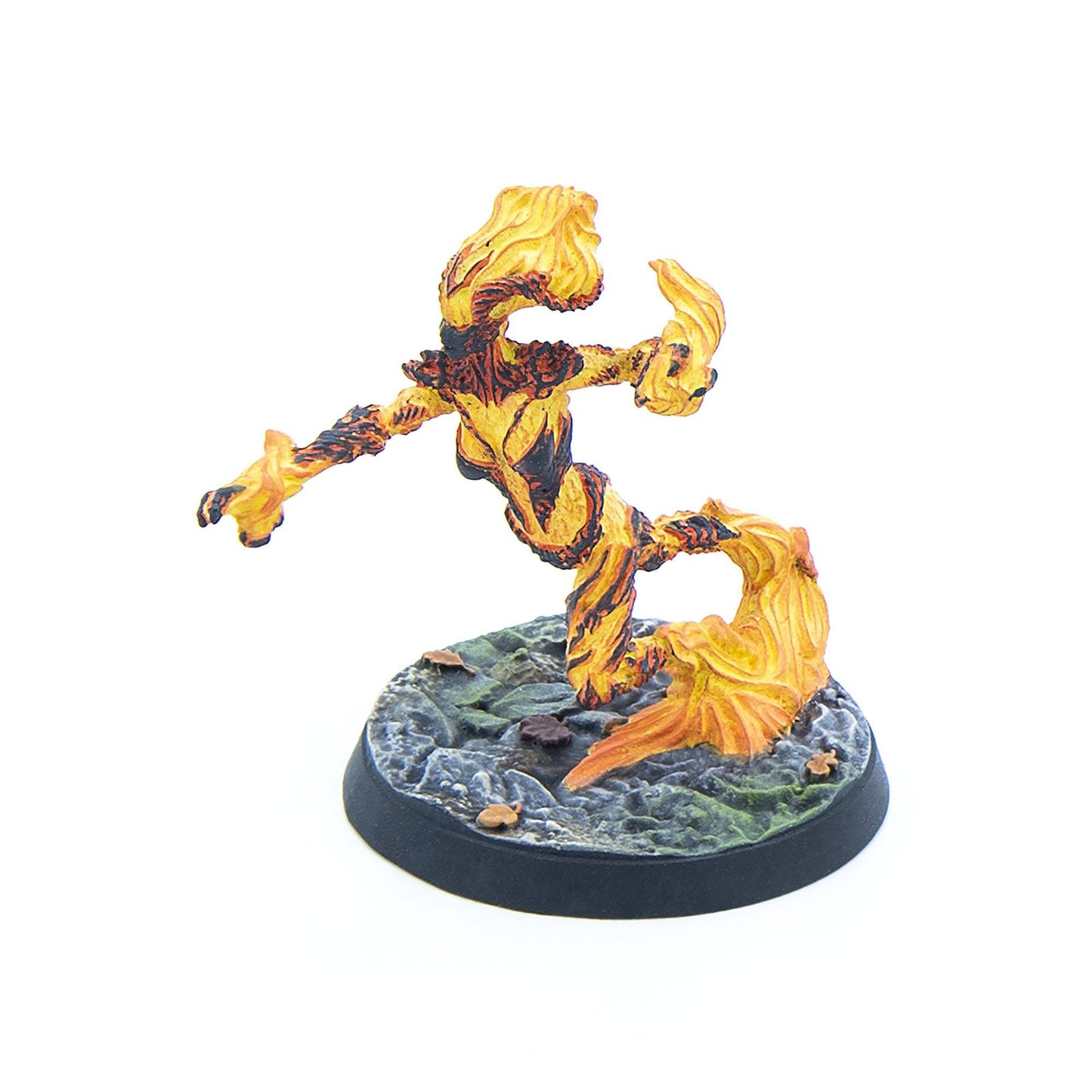 An orange and yellow flame elemental miniature, with dark streaks, depicted running on a rocky base